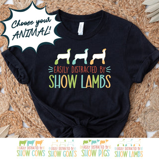 Black t-shirt with colorful text and animal graphics on a woven surface